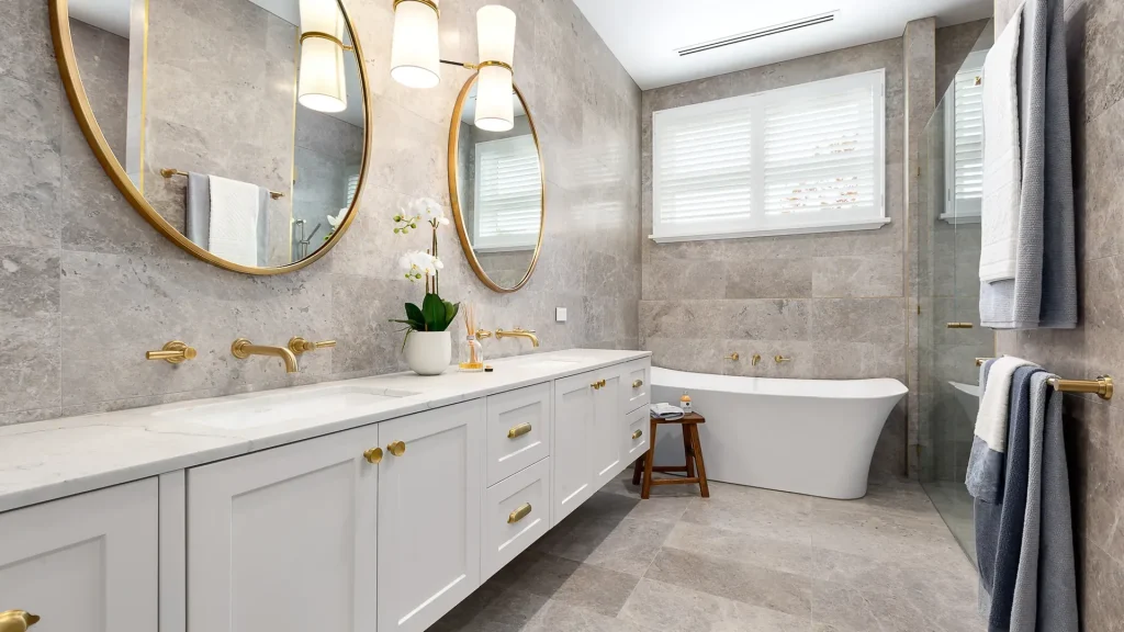 montauk luxury bathroom with gold fixtures and marble