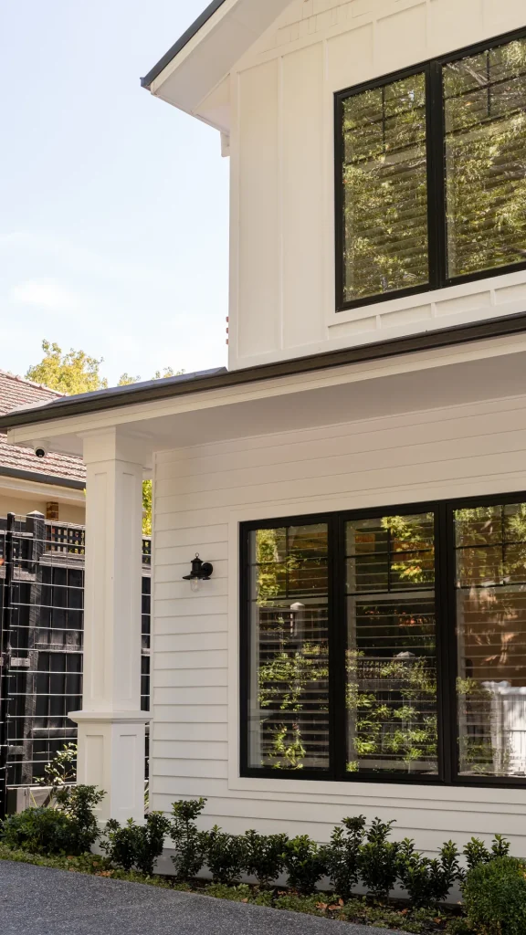 white gable custom home exterior black windows